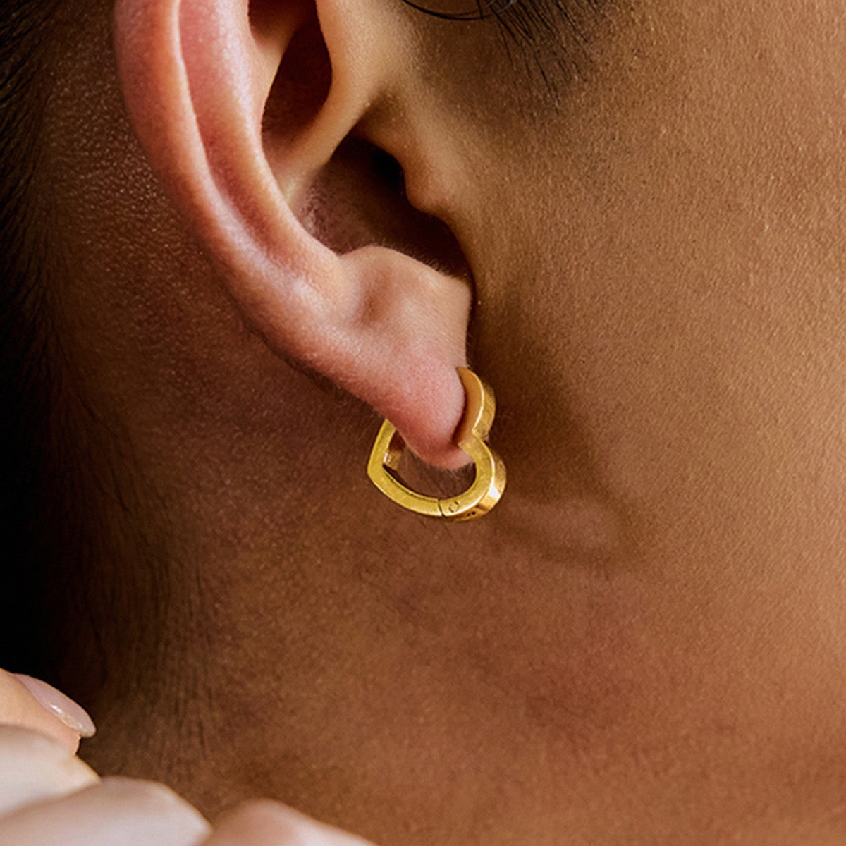 Love Earrings gold heart huggie earring worn on the ear