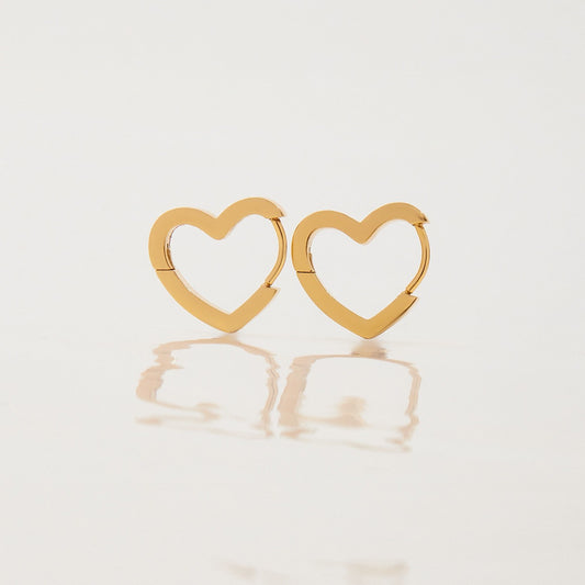 Pair of Love Earrings gold heart huggie earrings on a white background